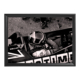 Framed black-and-white photo of Stefan Bellof seated in Formula race car cockpit.