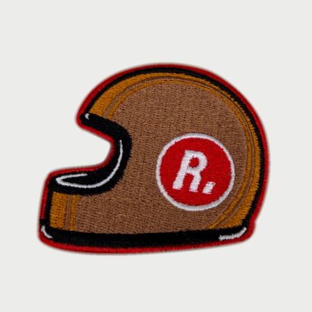 Embroidered Racing Relics patch shaped like a vintage helmet with red “R.” insignia.