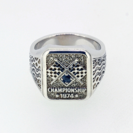 Sterling silver 1974 Championship Ring with sapphire-blue stone and Michelin XAS tire pattern engraving by Racing Relics.